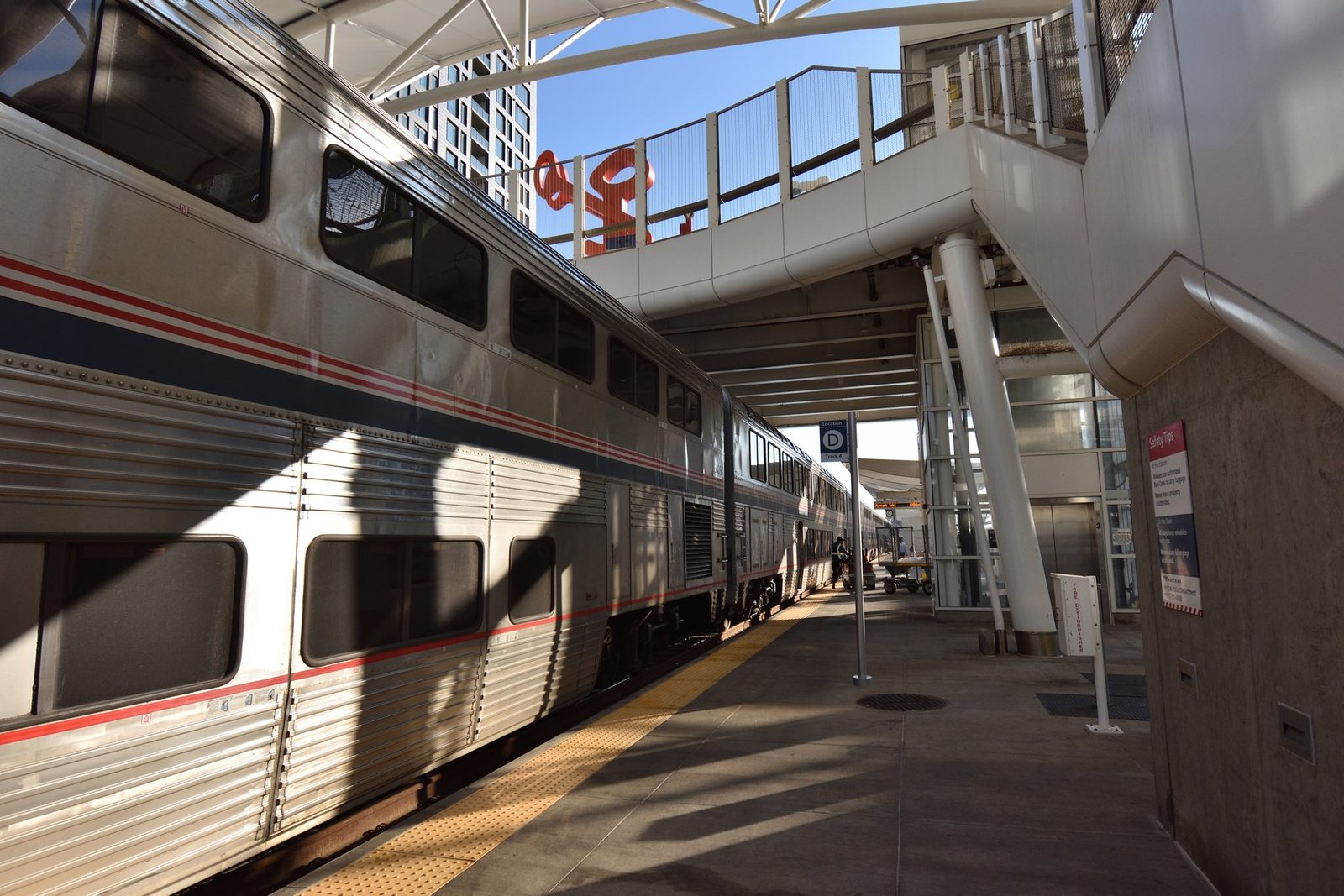 Passenger train boarding platform beneath a station canopy